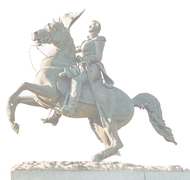 The image shows an equestrian statue of a person in military attire riding a rearing horse. The statue is mounted on a rectangular base.