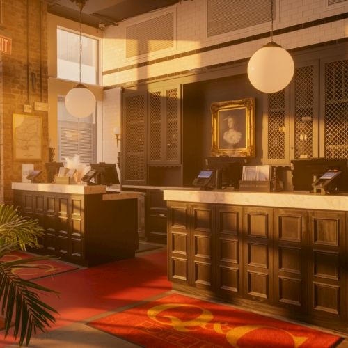 A hotel lobby with a wooden reception desk, warm lighting, potted plants, red patterned carpet, and round hanging lamps, inviting and elegant.